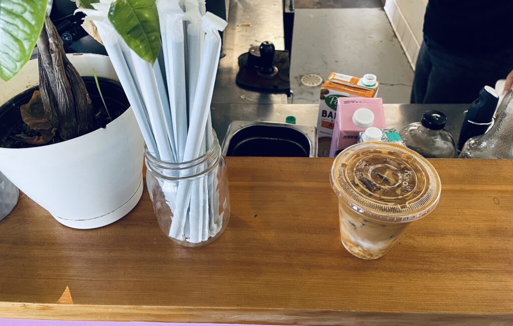 an iced coffee placed on brown countertop